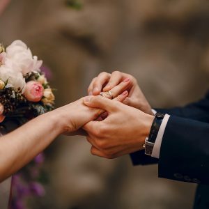 groom-putting-ring-on-bride-s-finger